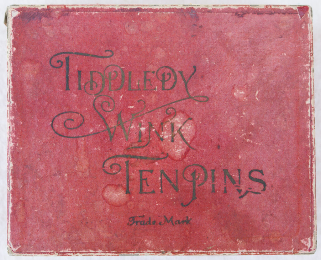 Tucker Tw ID • UNK-010v2c1 — AGPI ID • G-30137c1 — publisher • (unknown) — title • TIDDLEDY WINK TEN PINS — notes • Dark red cardboard cover without leatherette texture.